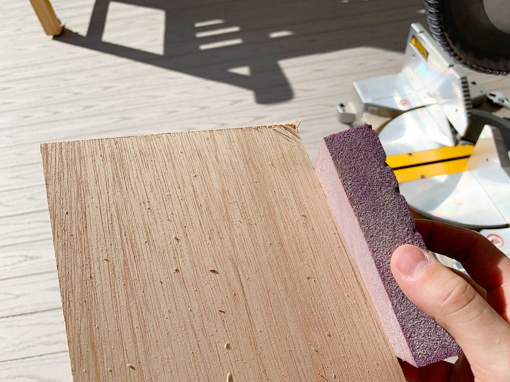 Sanding Rough Edges Of Wood Panel Strip Using Sanding Block