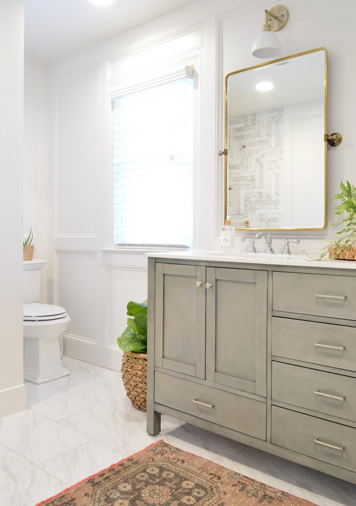 Master Bathroom Update With Gray Vanity Installed With Brass Mirror