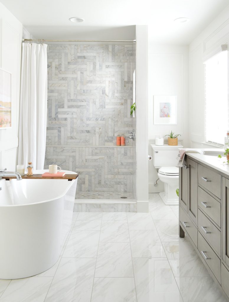 After Photo Of Bathroom With Large Walk-In Herringbone Marble Tile Shower And Freestanding Tub