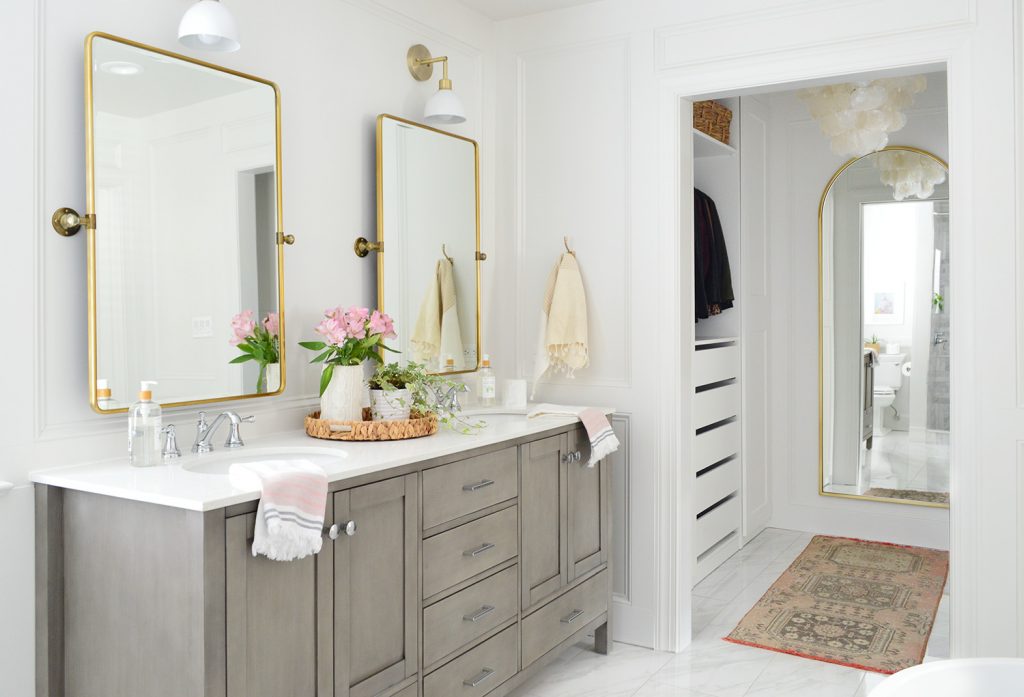 Large main bathroom after photo with gray vanity and walk in closet and arched mirror