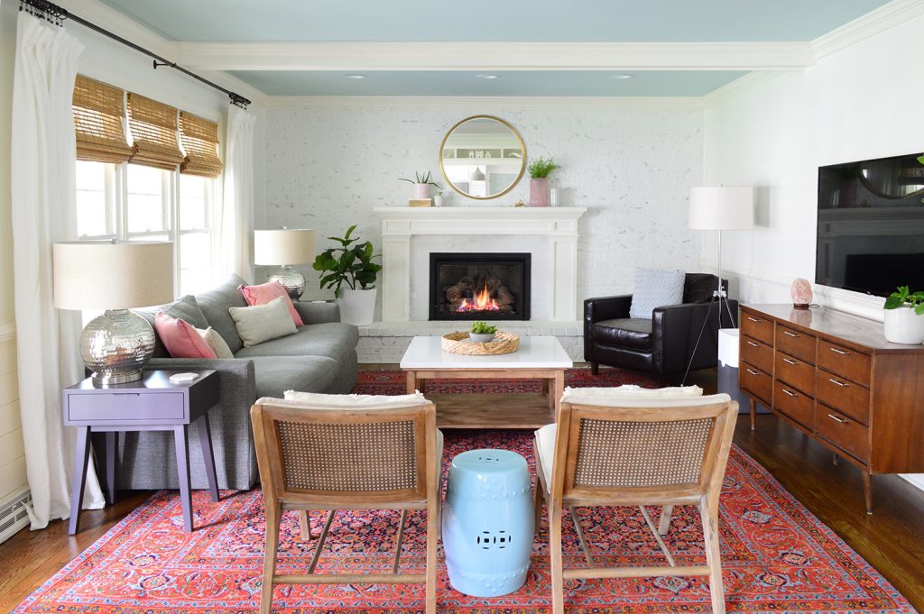 White living room with traditional rug and fireplace