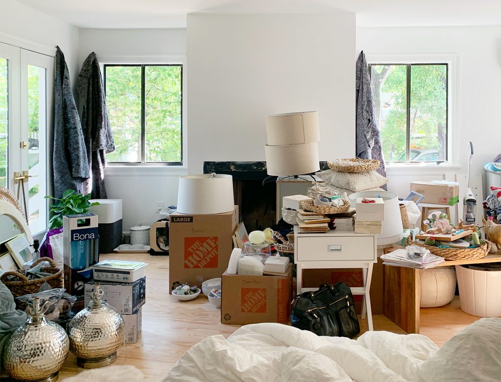 Moving Photo Of Bedroom Chaos Covered in Moving Boxes And Drop Cloth Curtains