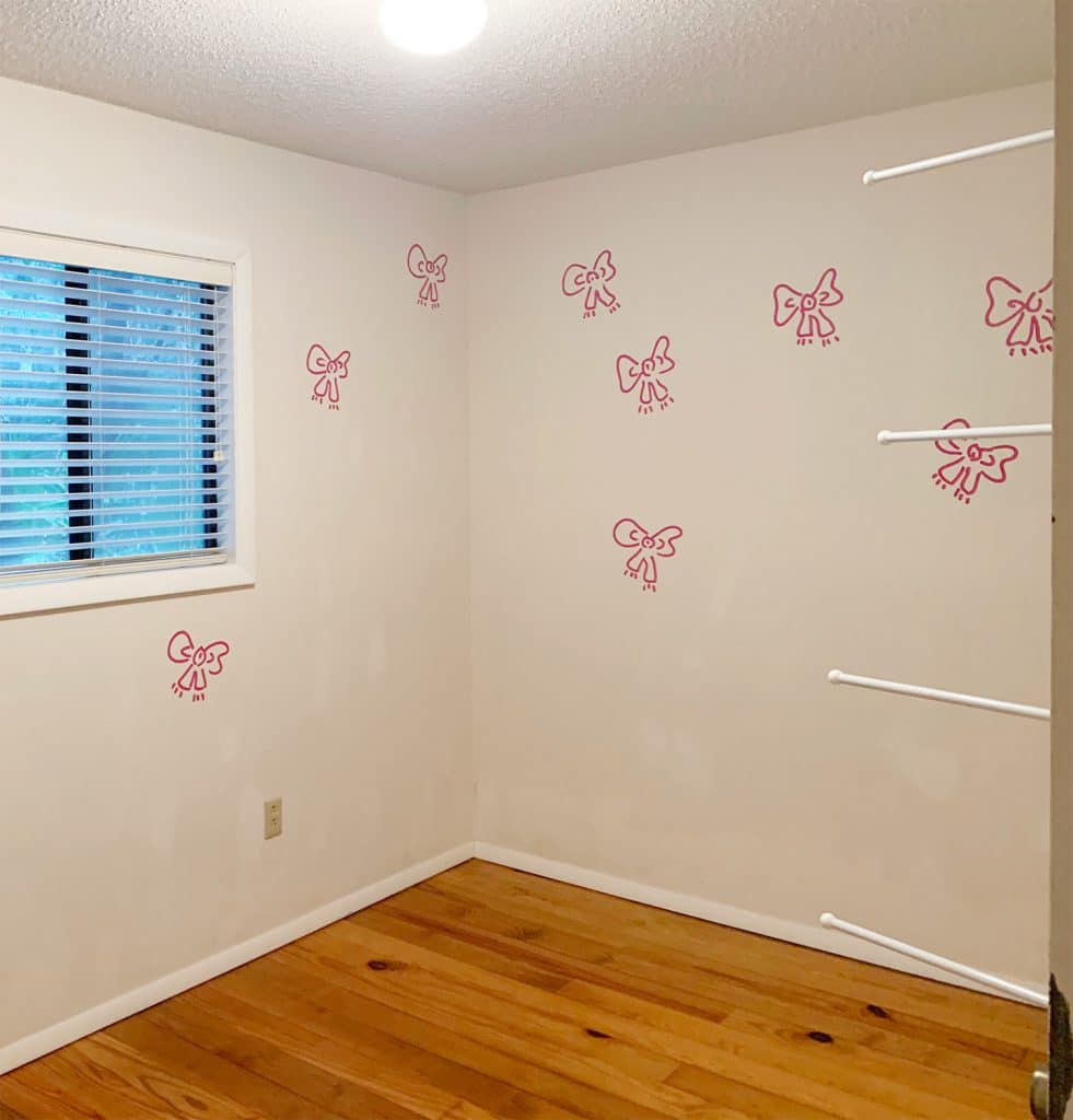 Before Photo Of Boys Room Showing Small Window And Paint Bow Artwork On White Walls