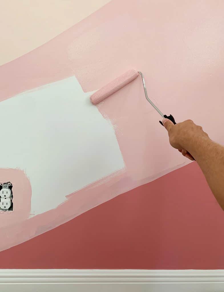 Filling in abstract mural with paint roller