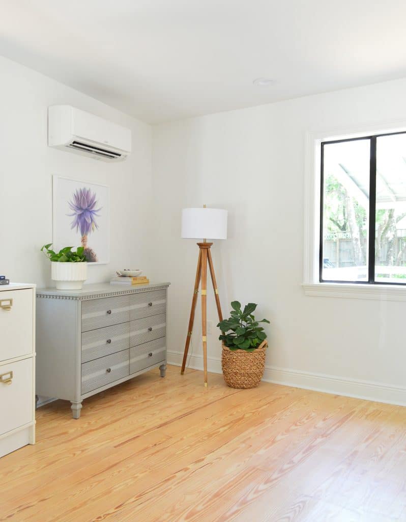 Before photo of bedroom corner with random dressers in corner