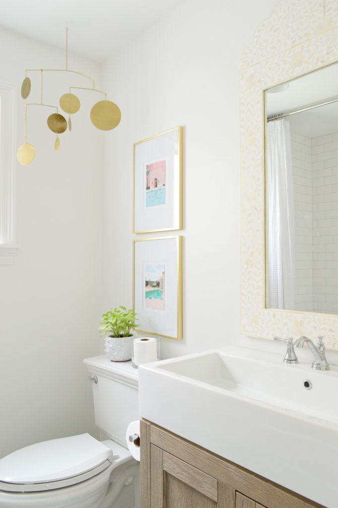 Bright modern bathroom with wood vanity and gold accents