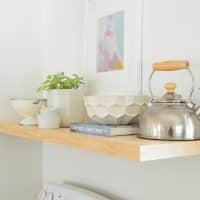 Detail Of Wood Floating Pine Shelf In Kitchen With Tea Kettle