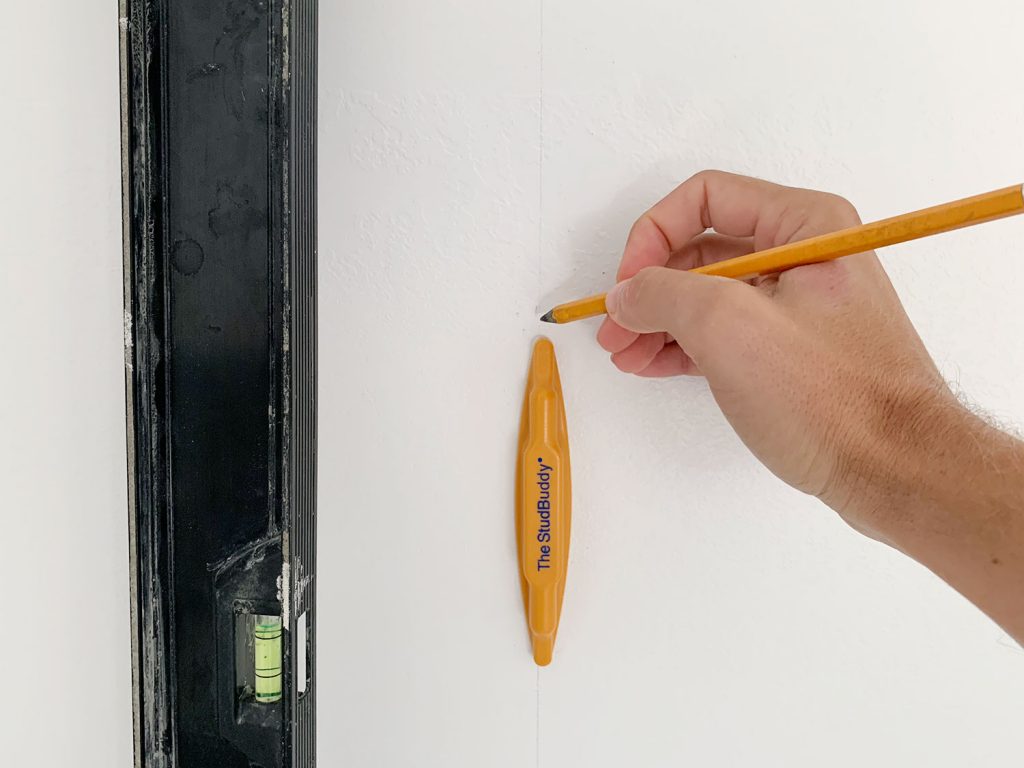 Hand Marking Vertical Level Line On Wall Using StudBuddy Stud Finder