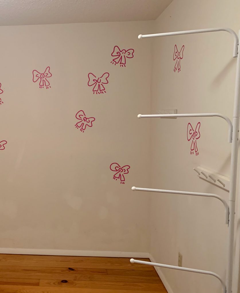 Before photo of boys room with pink bows painted on walls