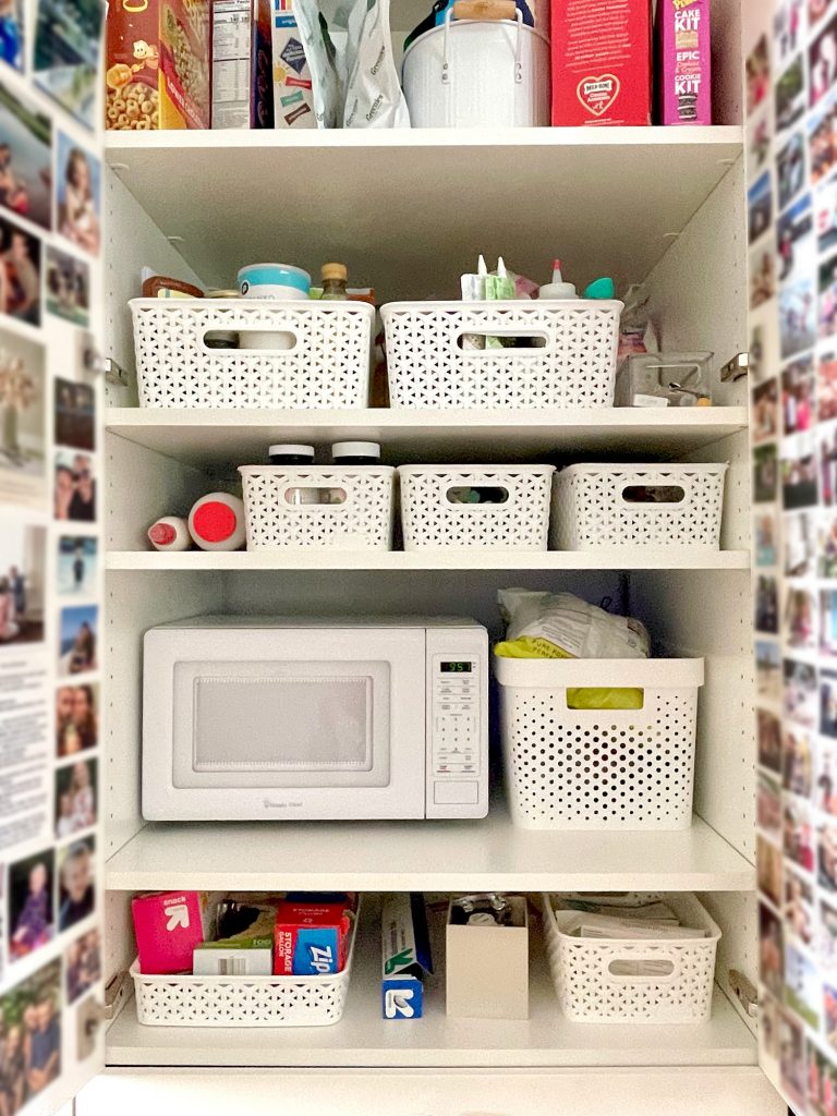 Close Up Shot Of Pantry Shelves With Baskets And Microwave