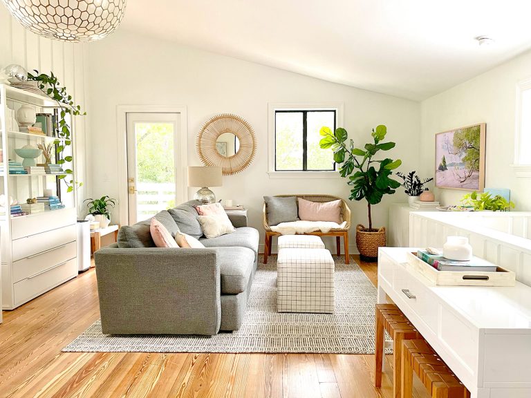 Modern White Family Room With Gray Couch Woven Mirror And High Ceilings