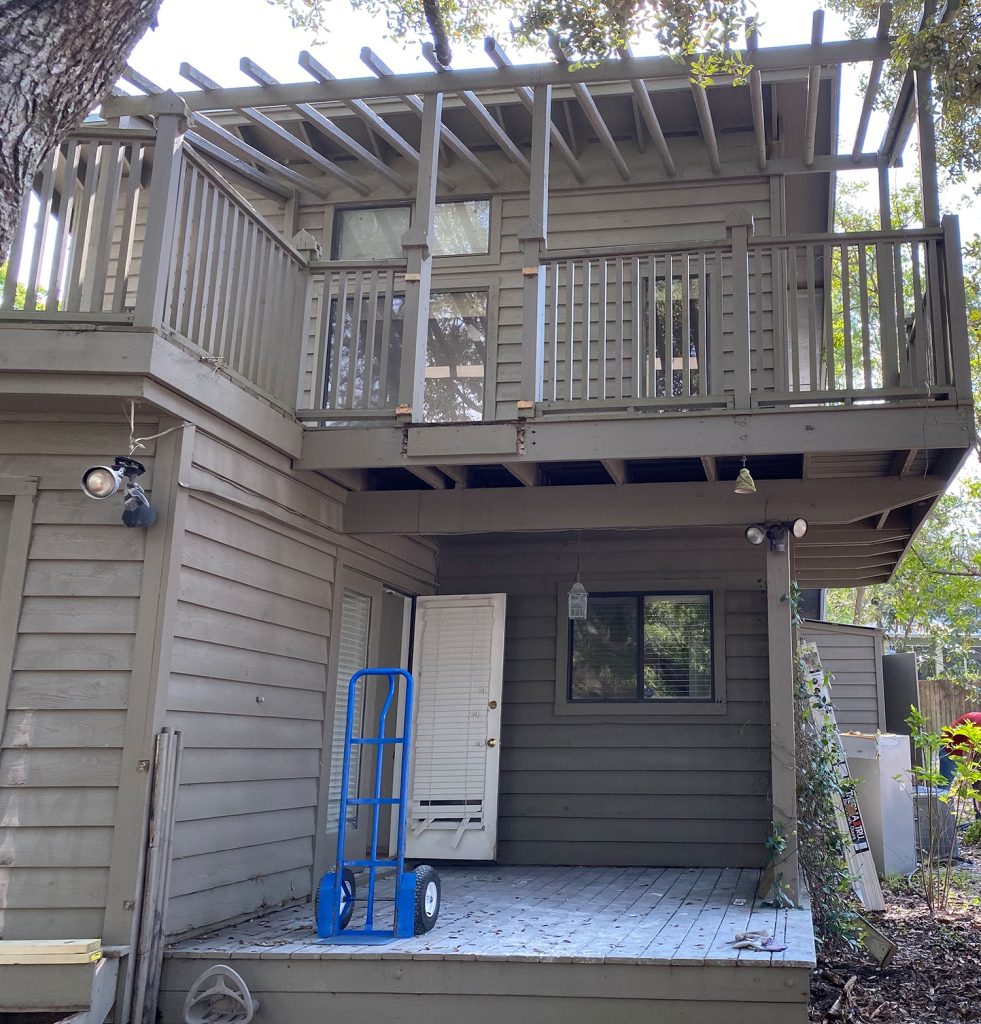 Before photo of kitchen porch area with brown siding