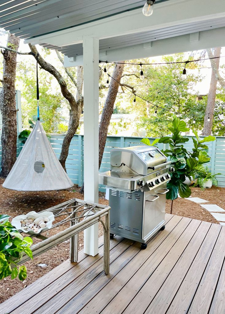 View of side yard with hanging swing and grill