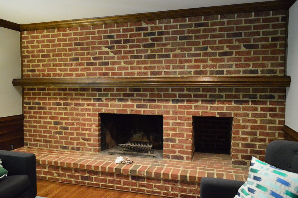 dark living room brick wall with a fireplace from 1980s home