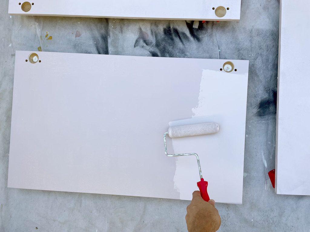 Applying Pink Paint To Ikea Kitchen Cabinet Doors With Small Foam Roller