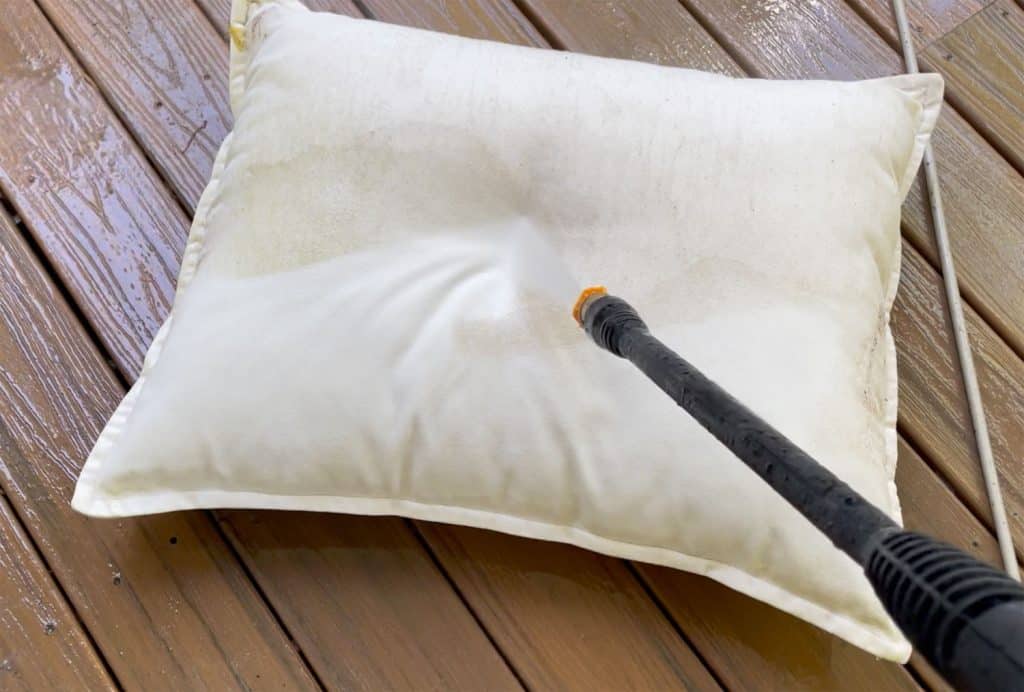 Spraying Outdoor Pillow With Electric Pressure Washer