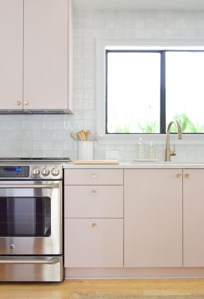 Vertical View Of Mauve Pink Painted Ikea Kitchen Cabinets With Gray Tile Backsplash