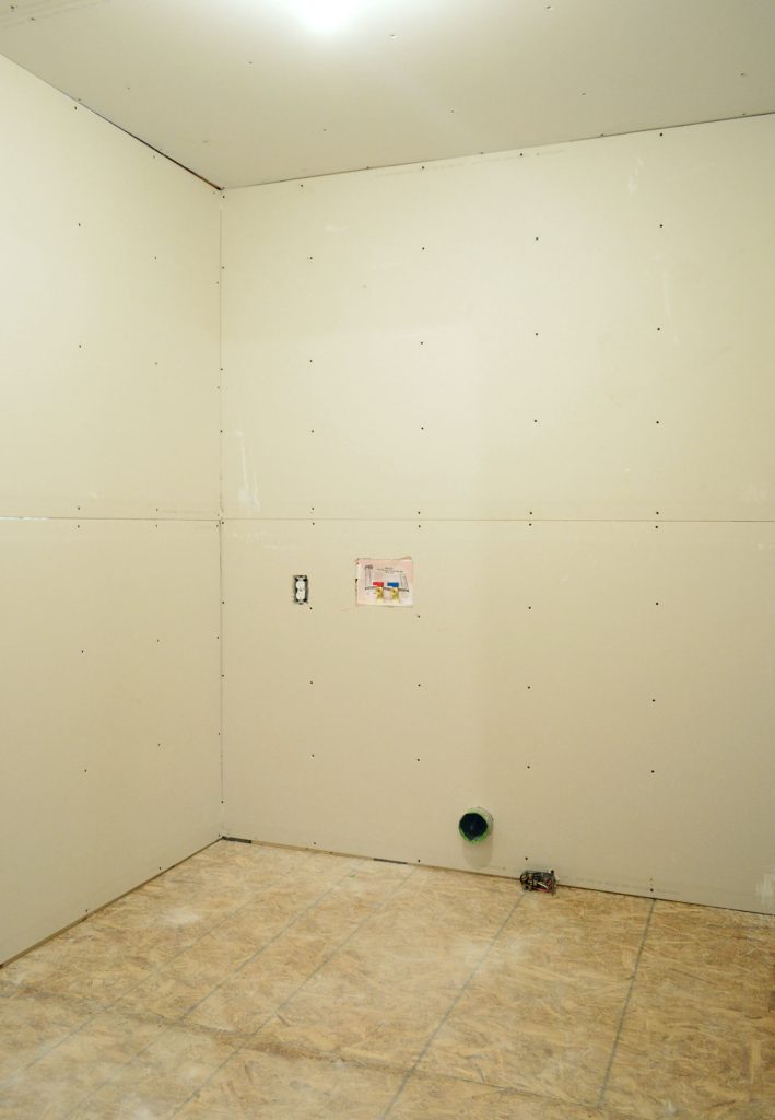 inside photo of laundry room after drywall installation was completed