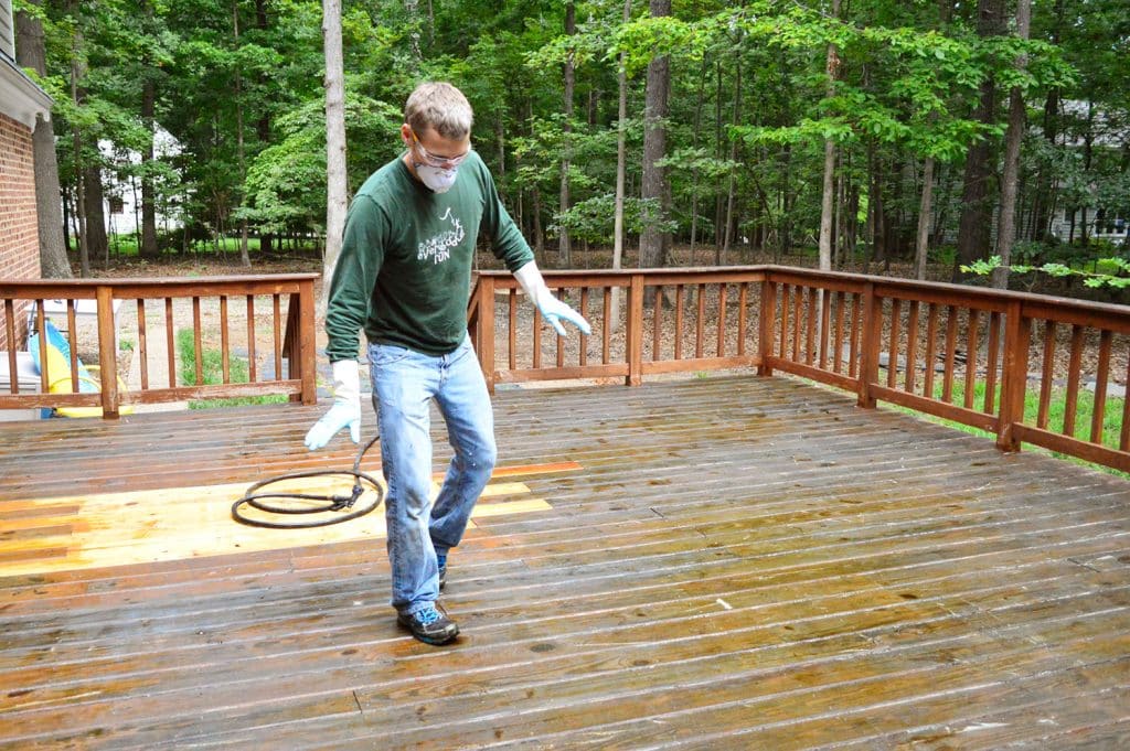 John tip toeing on wet deck surface 