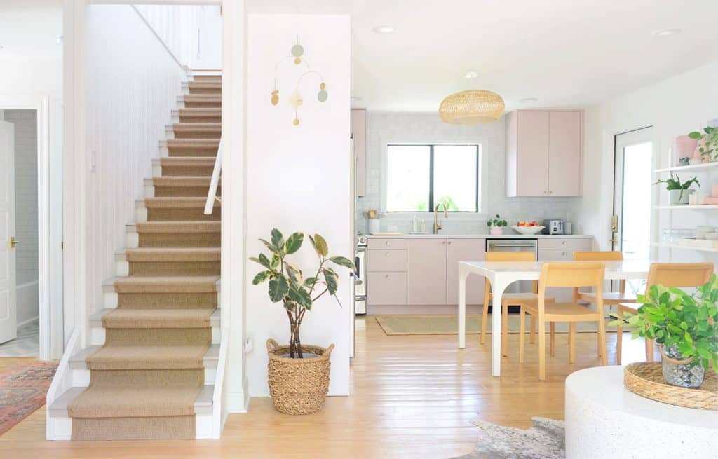 View From Front Door Of Stairs And Mauve Pink Painted Kitchen Cabinets