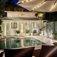 Nighttime View Of Back of House With Pool And Solar LED Lighting