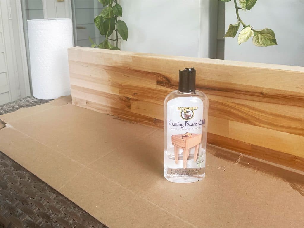 Butcher block counter being coated with cutting board oil sealant