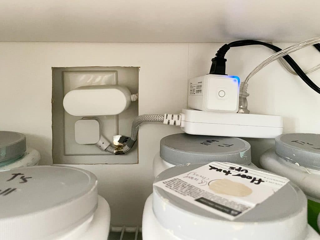 Detail of plugs and wires inside the Ikea Besta storage unit
