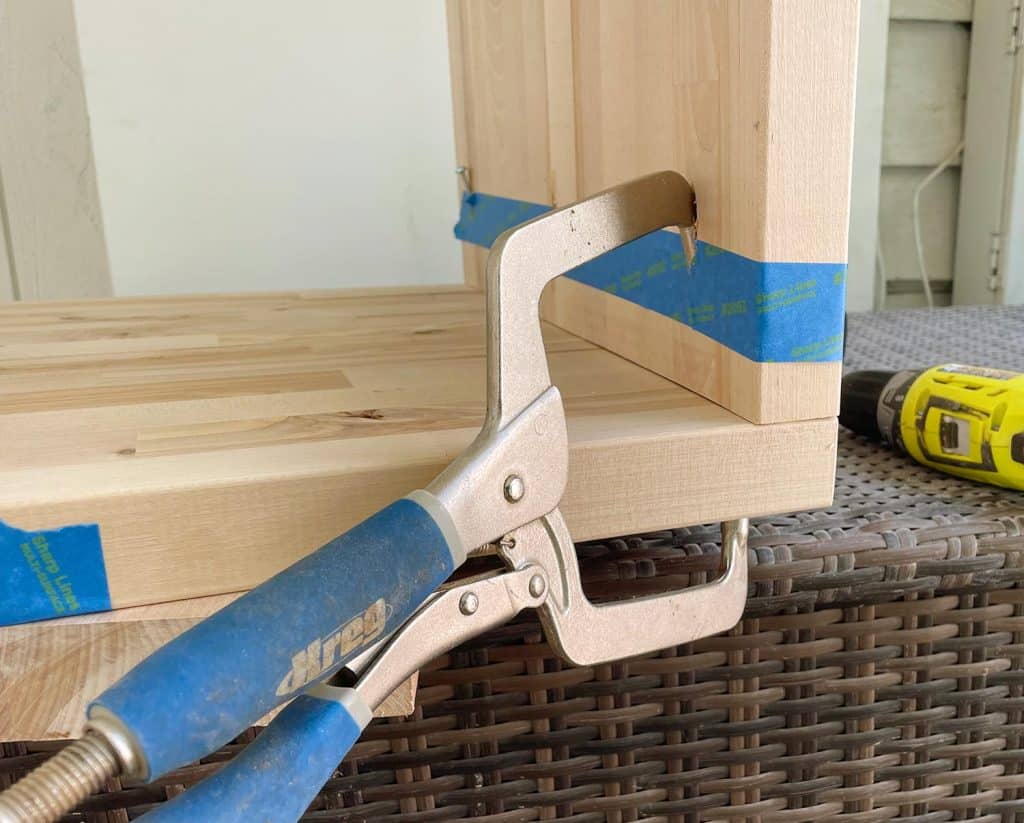 Kreg Pocket Hole Clamp Holding Butcher Block Nightstands Together During Construction