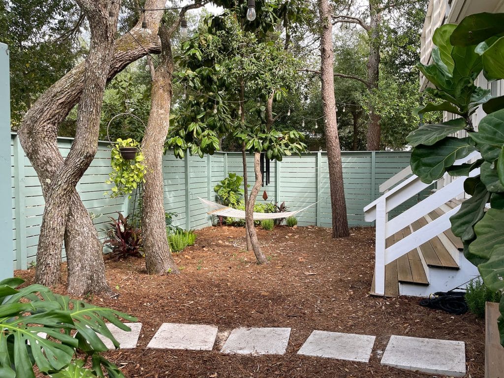 Full View Of Side Yard With Hammock Hanging Among Trees