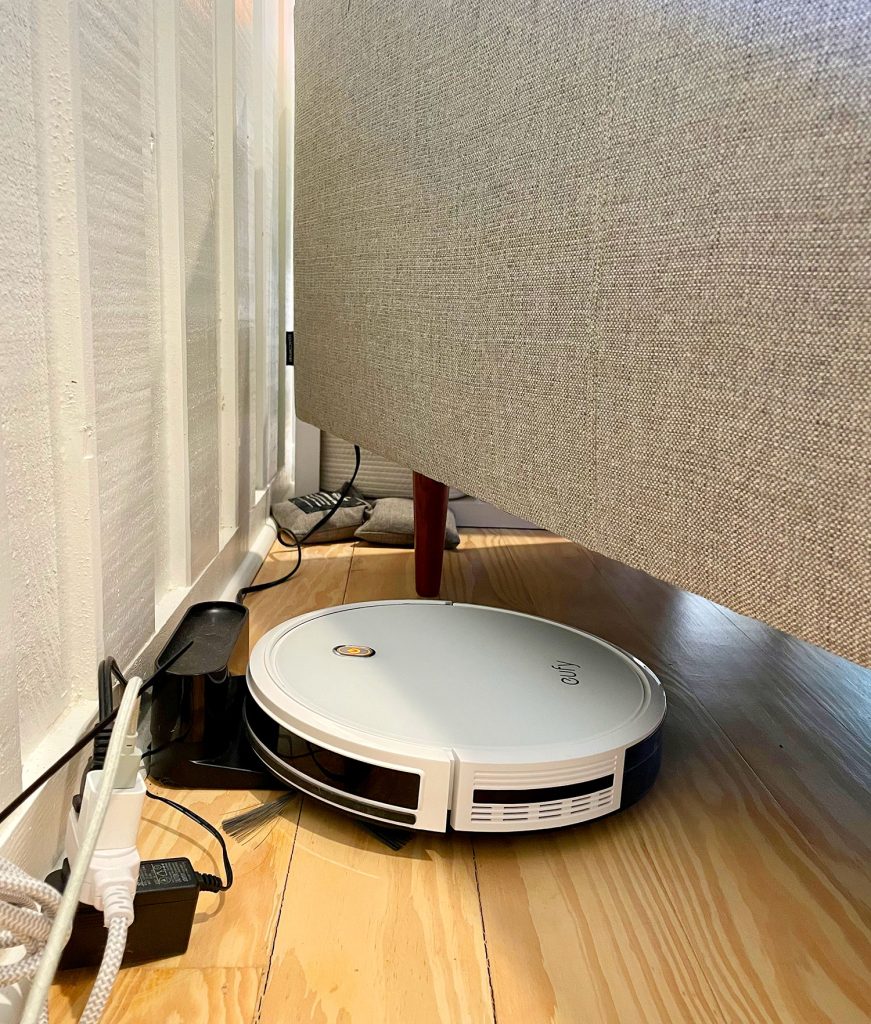 Eufy RoboVac 11S Charging At Base Station Plugged In Under Couch