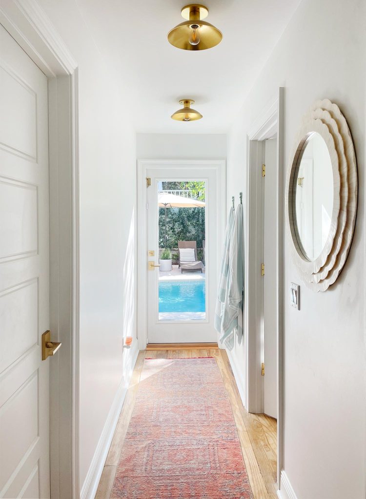 Hallway With Traditional Rug Leading To Pool