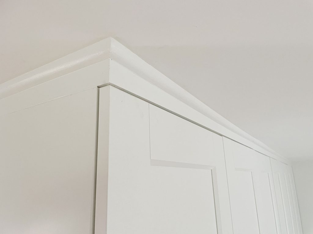 Finished and painted quarter round molding that makes Ikea Pax Wardrobes look built in