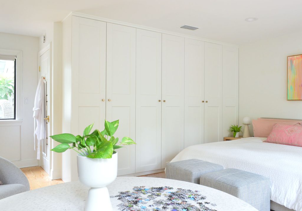 Row of Ikea Pax Wardrobes In Bedroom With Puzzle Table In Foreground