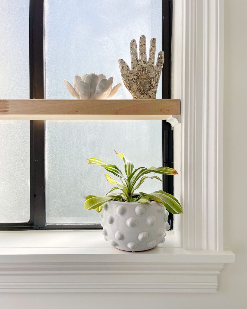 Floating Wood Shelf In Simple White Bathroom With Plants