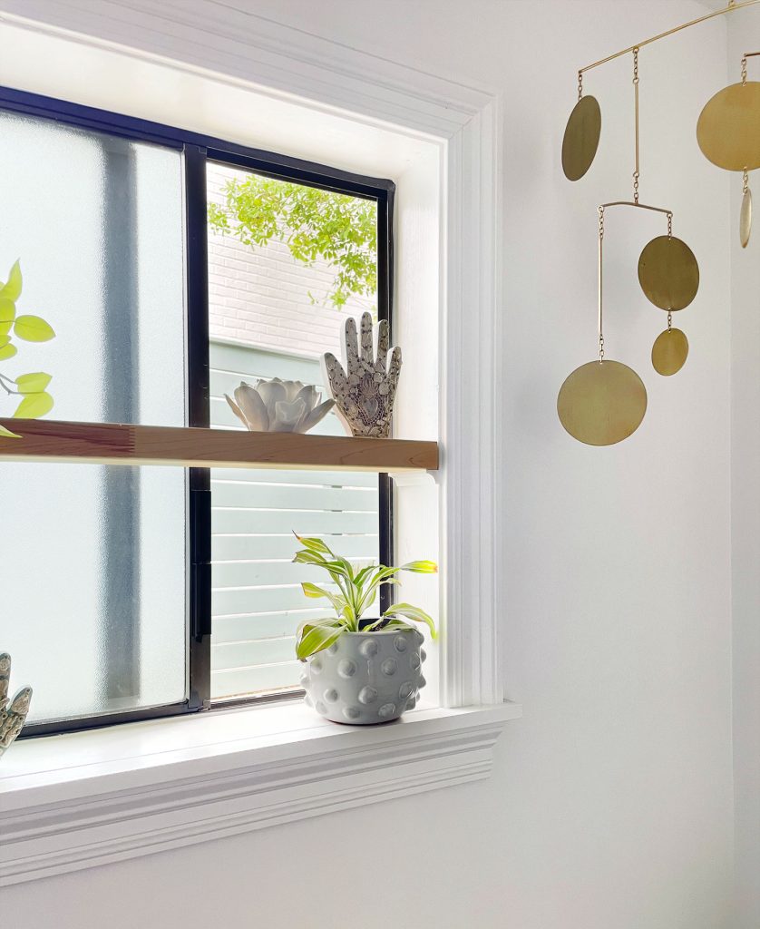 Floating Shelf In Bathroom With Window Open Behind It