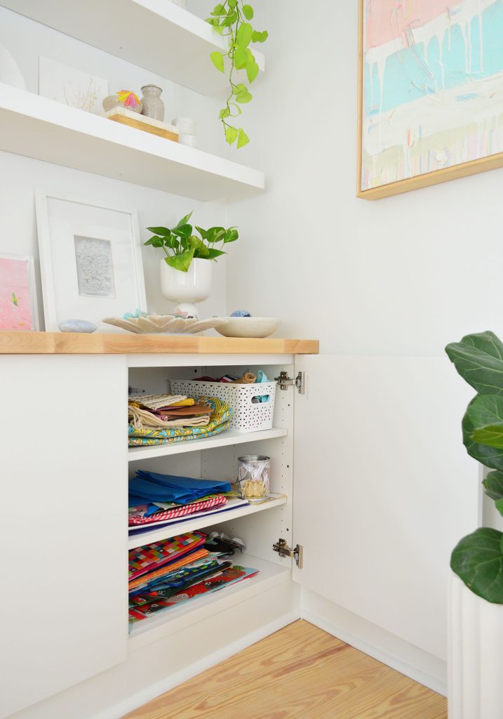 Open Besta Cabinet Under Floating Shelves With Gift Wrap Storage