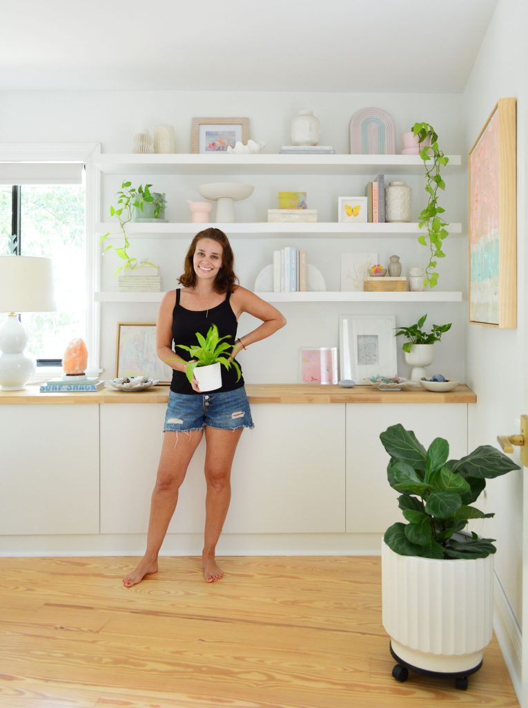Sherry Standing With Plant In Front Of Ikea Lack Floating Shelves
