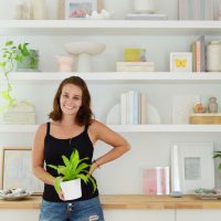 Sherry Standing In Front Of New Ikea Floating Lack Shelves