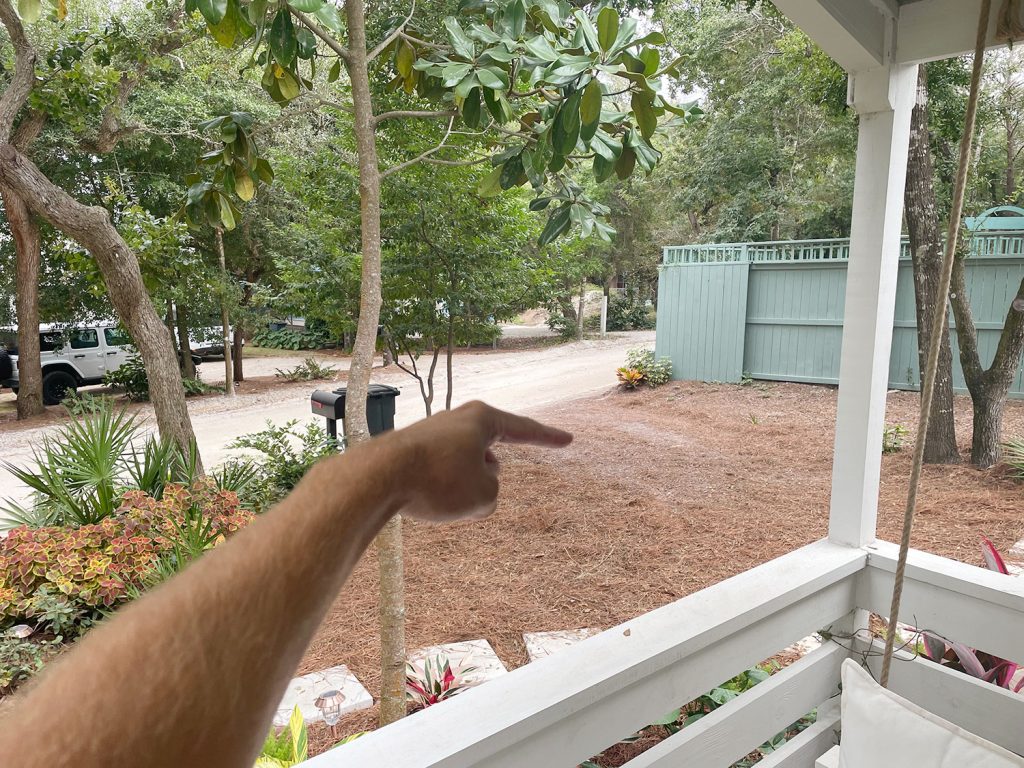 Finger Pointing to Spot In Pine Straw For Car To Park