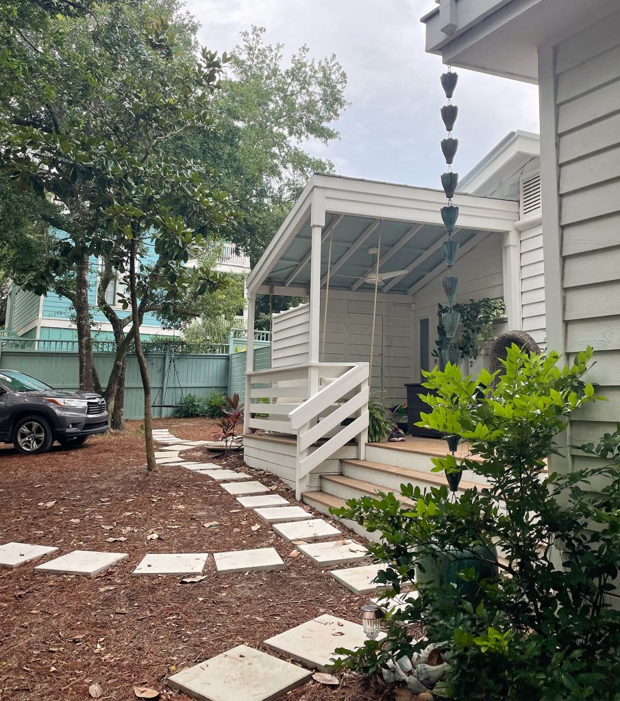 Side view of home with small stone paver walkway in front of home