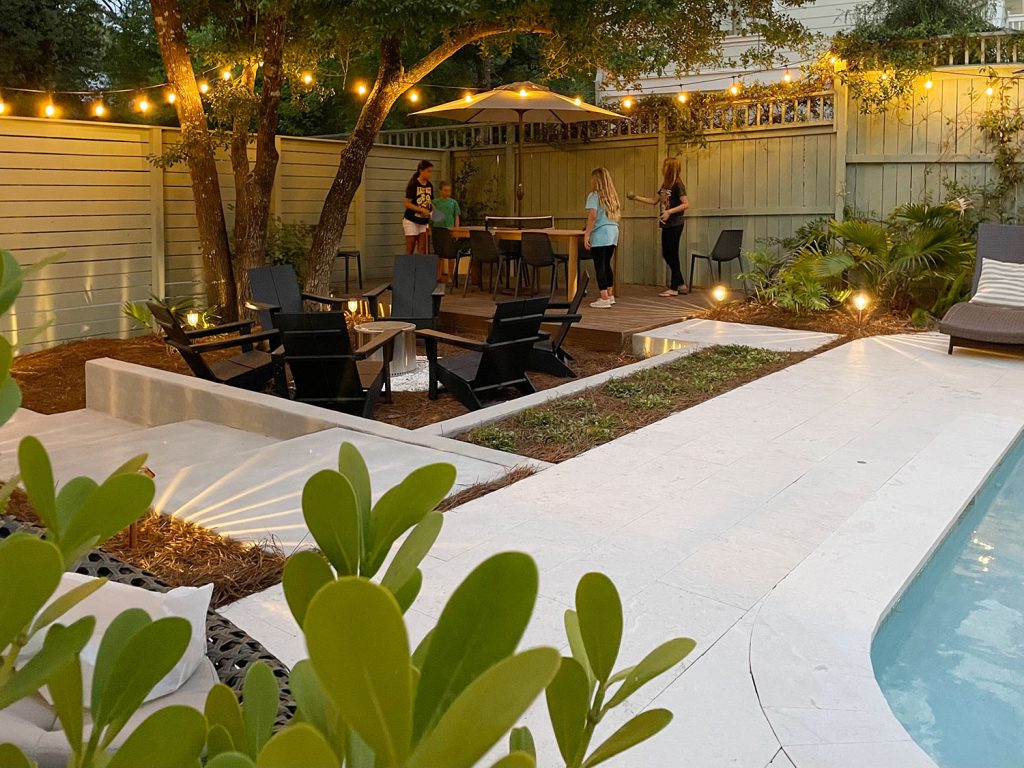 Backyard Pool Area With Kids Playing Ping Pong On Dining Table