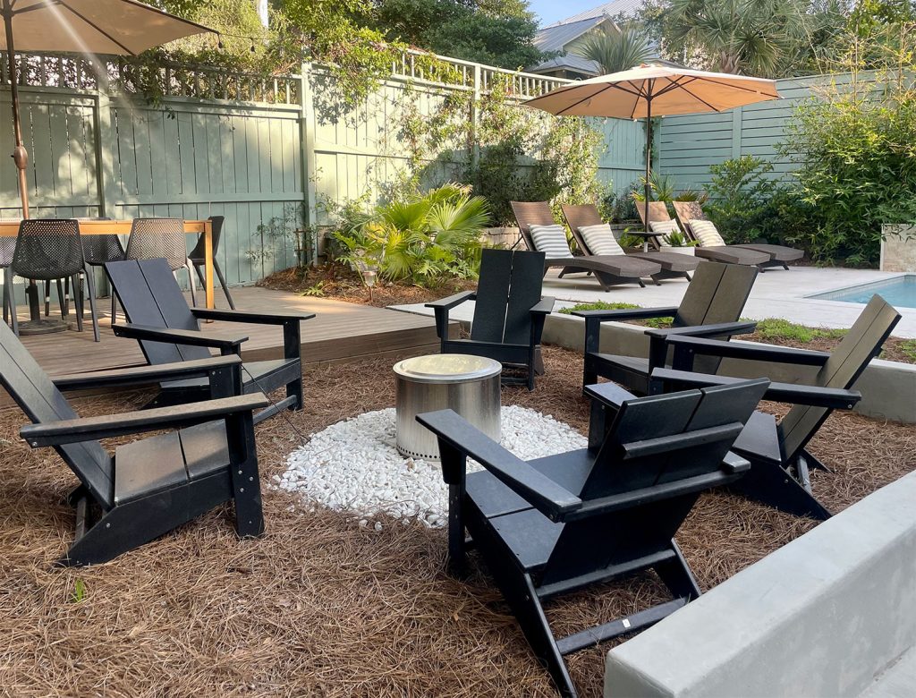 Solo Stove firepit area with black Adirondack Chairs