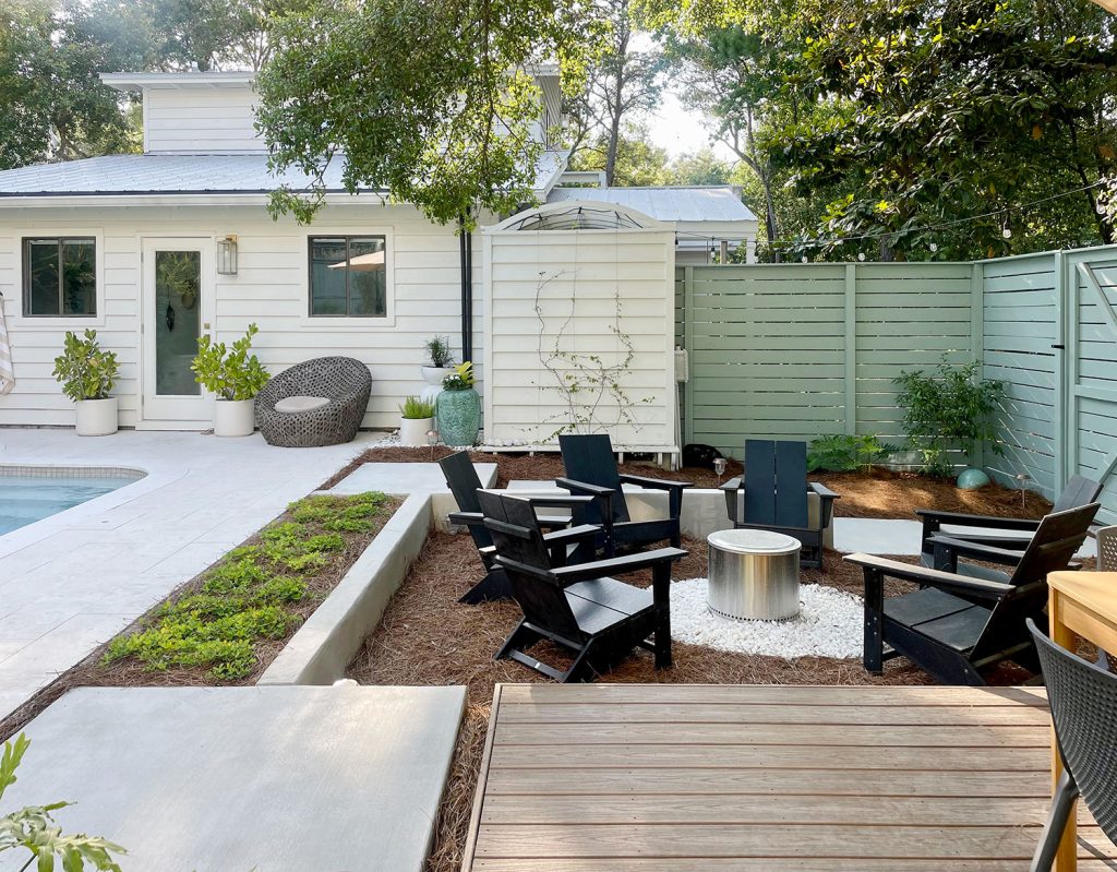 Sunken firepit area in larger backyard next to pool