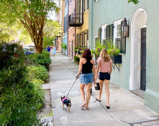 Family With Dog And Children Walking On Rainbow Row In Charleston South Carolina