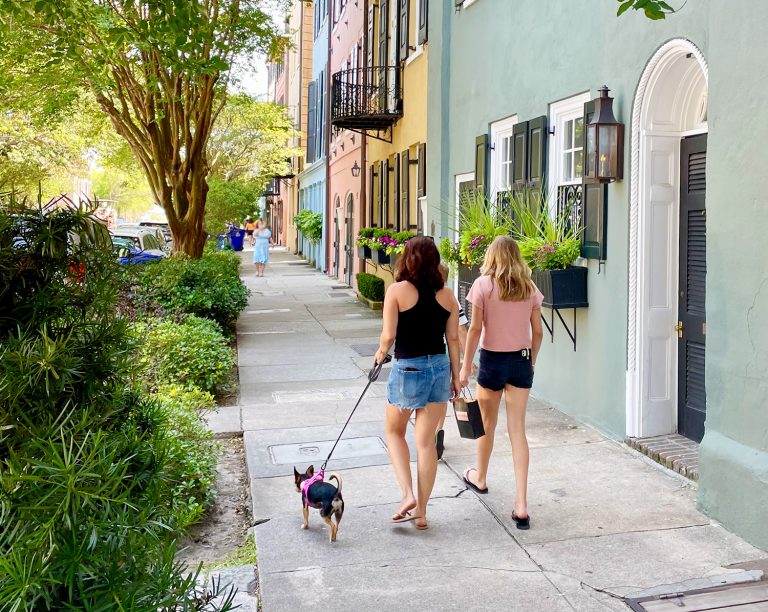 Family With Dog And Children Walking On Rainbow Row In Charleston South Carolina