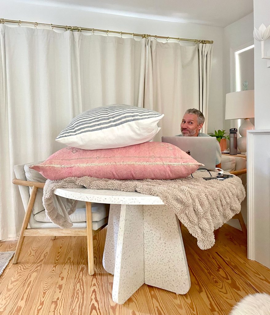 John Sitting Behind Pillows For Podcasting Record