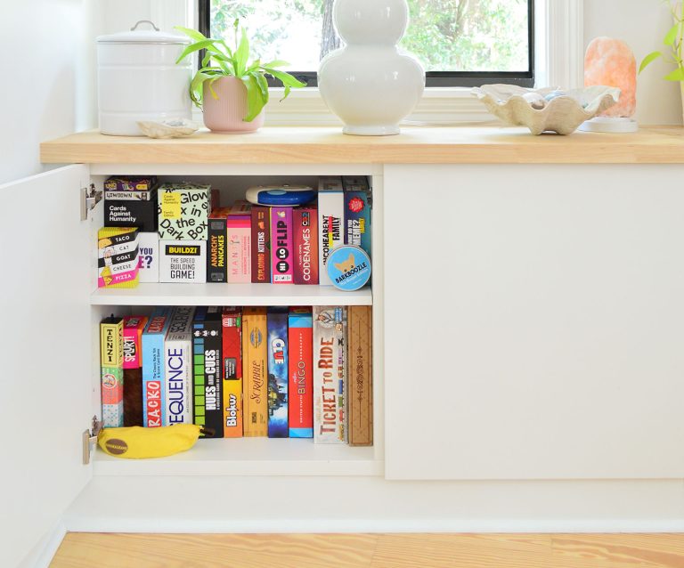Ikea Besta Cabinet With Door Open Showing Family Board Game Storage