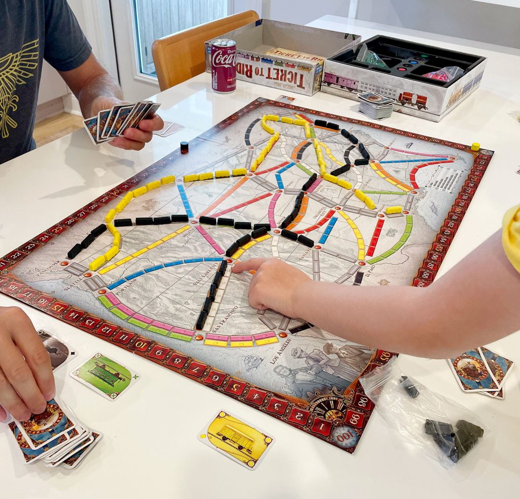 Family Playing Ticket To Ride Original Version