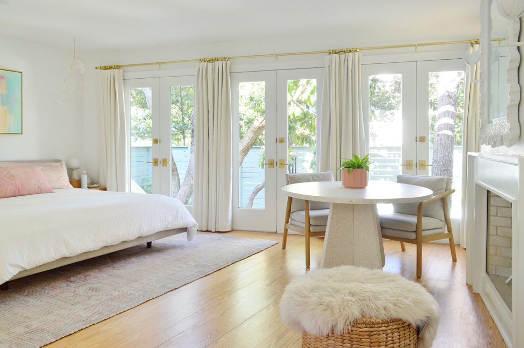Bright Beachy Bedroom With Wall Of French Doors And Curtains