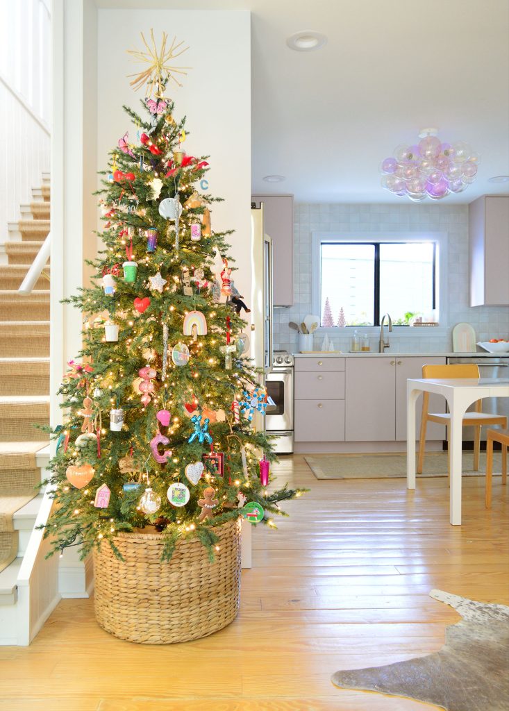 Slim Artificial Christmas Tree In Kitchen With Pink Cabinets